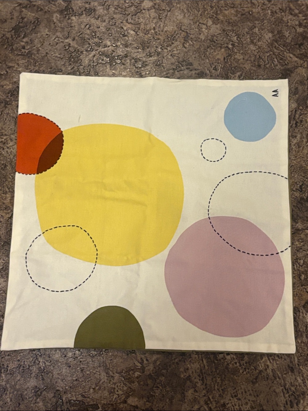 IKEA ÄNGSMÄTARE cushion cover (50x50 cm), featuring a colorful, abstract circl